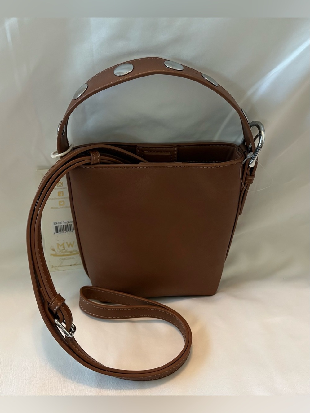 Madison West Brown/ Silver Studded Mini Bucket Bag  has detachable crossbody